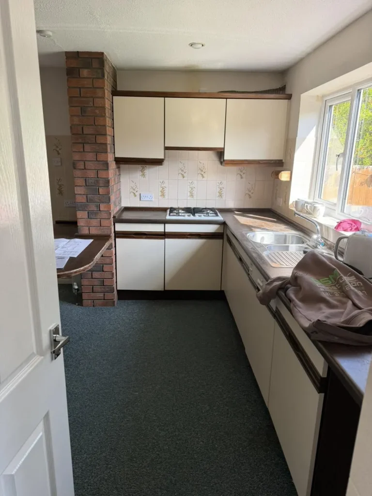 The original galley kitchen before work began, with dated units and worktops