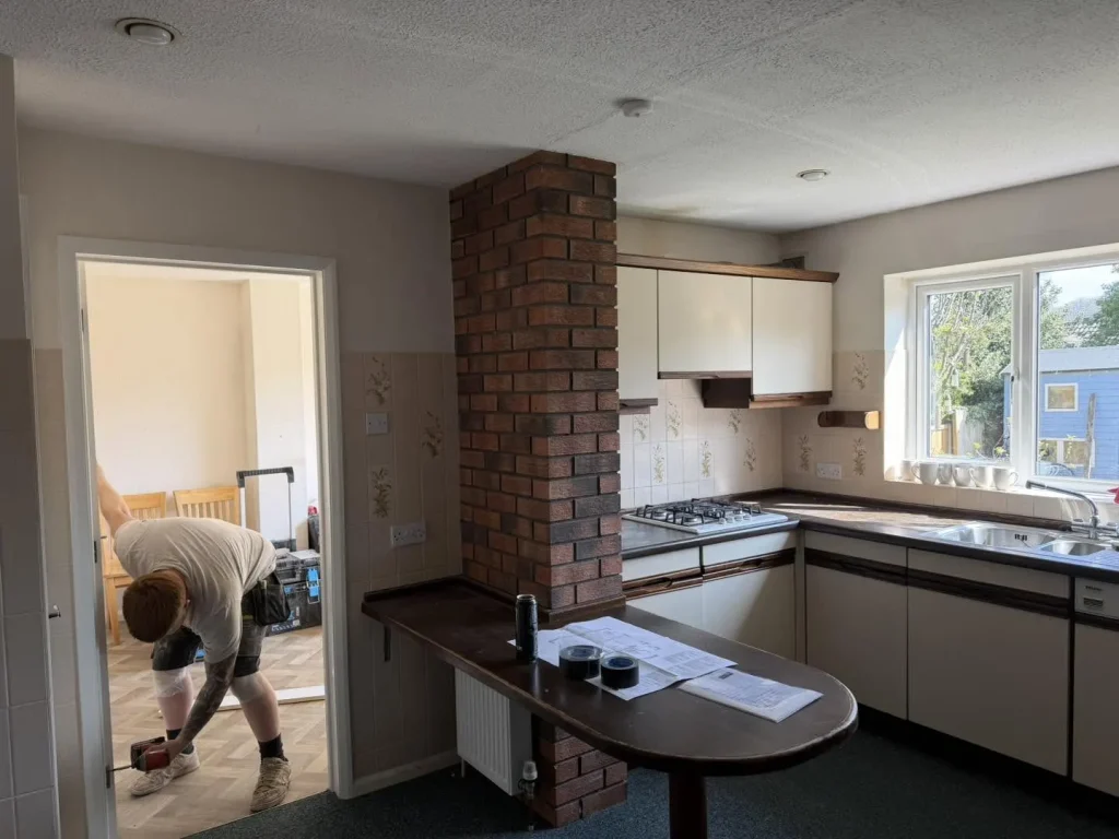 The kitchen and dining room before renovation, still divided by the internal load-bearing wall