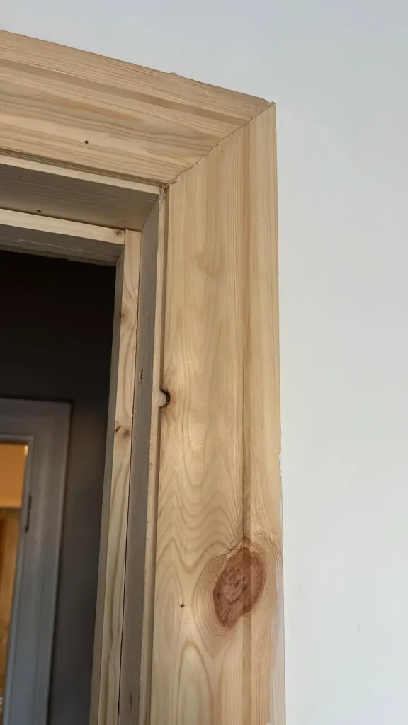 Period-matched architrave and door lining detail in new pine, ready for decoration