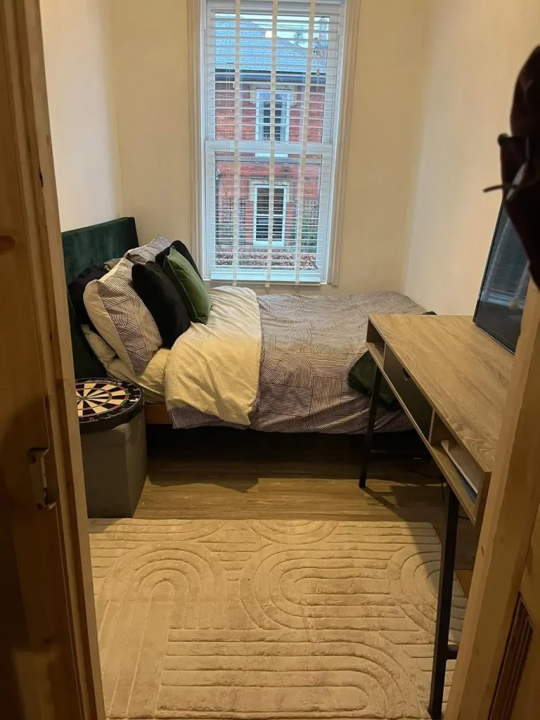 The finished fourth bedroom with the new sash window and period-matched joinery