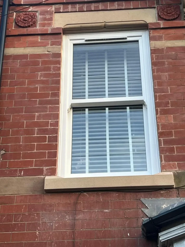 New sash window with stone sill and head cut to match the original 1865 stonework