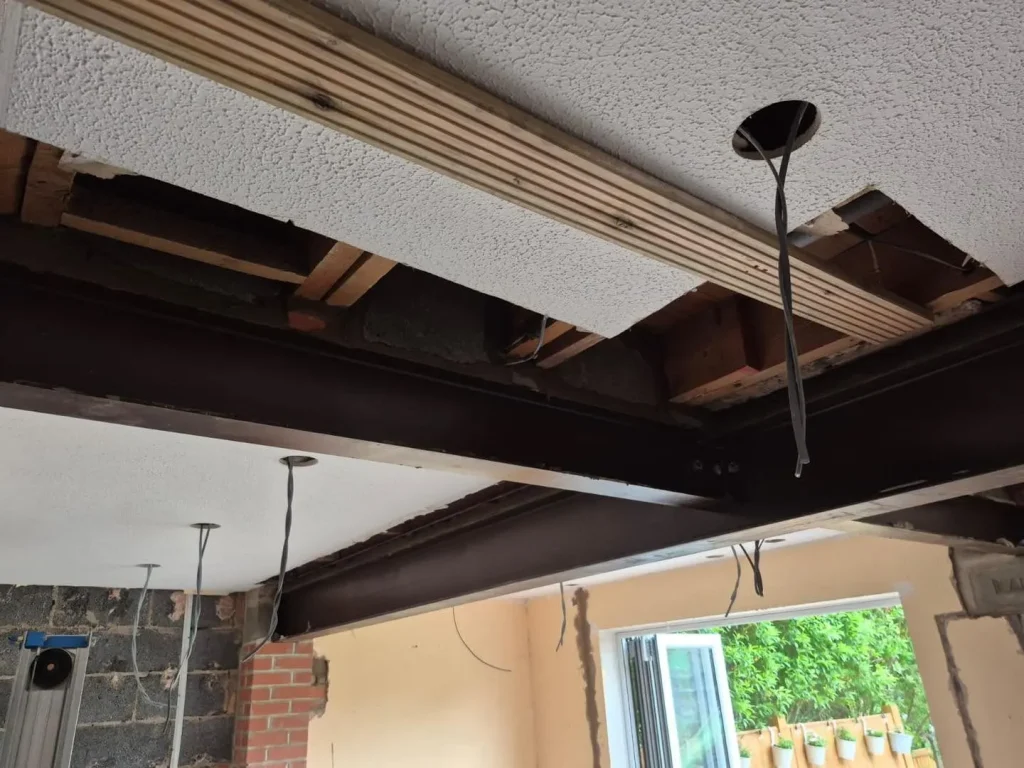 Steel beams with bolted connections in place, with the exposed joists packed up and secured