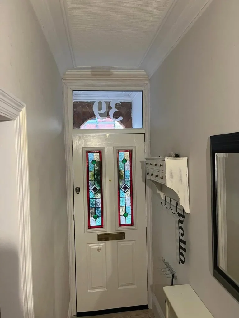 The new composite front door and numbered fanlight seen from the hallway