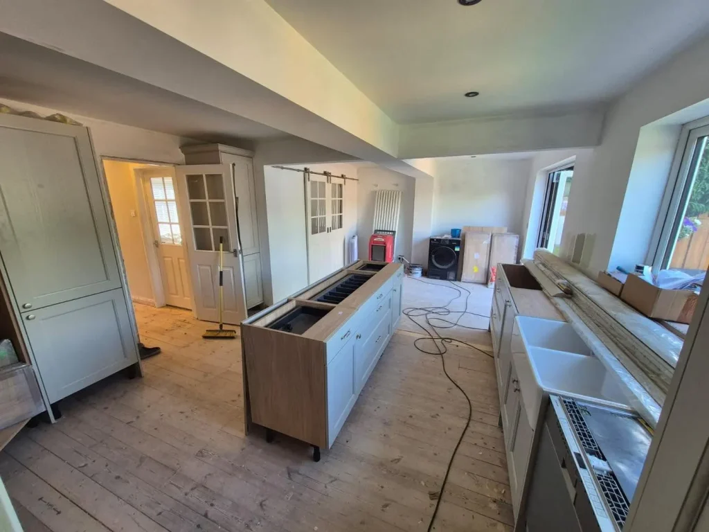 Kitchen units and the island carcass being installed before flooring