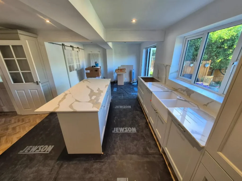 The kitchen installation nearing completion, with the island and quartz worktops fitted