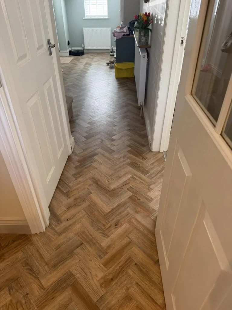 Oak-effect herringbone LVT flooring fitted through the downstairs