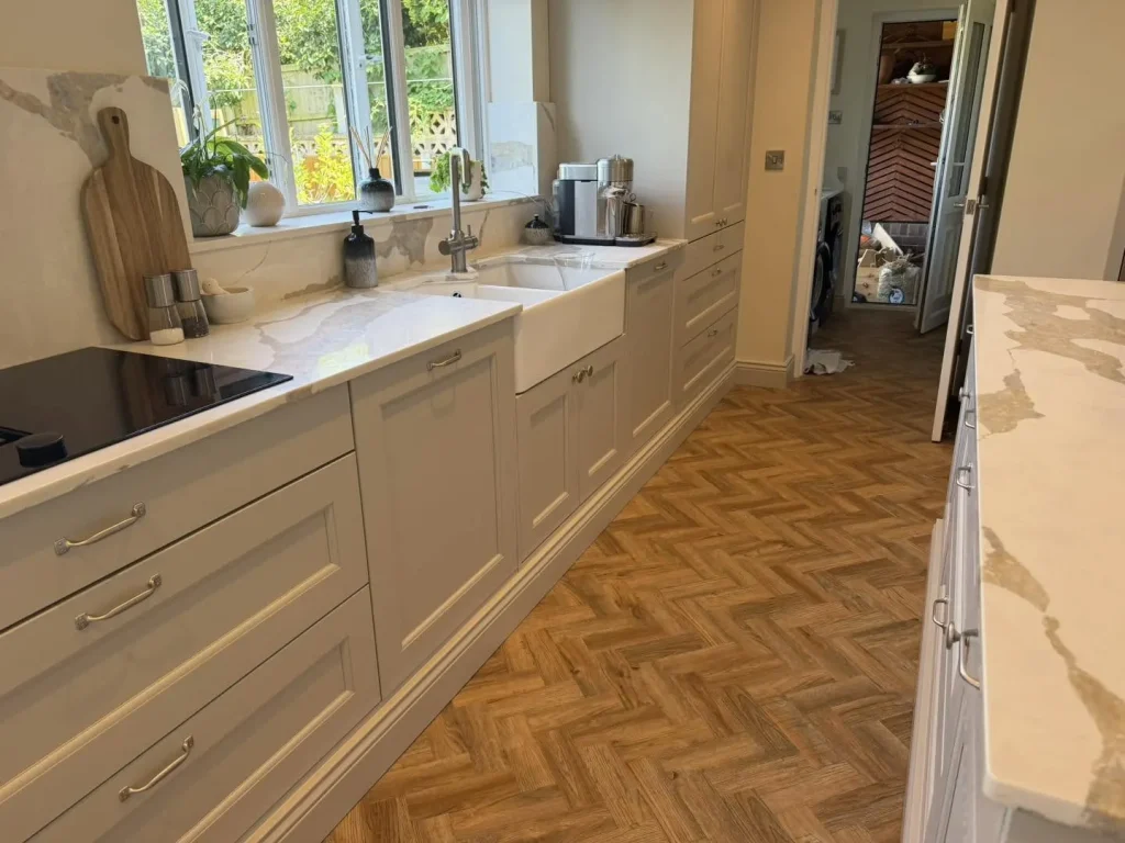 The finished run of kitchen units with Belfast sink and quartz worktop