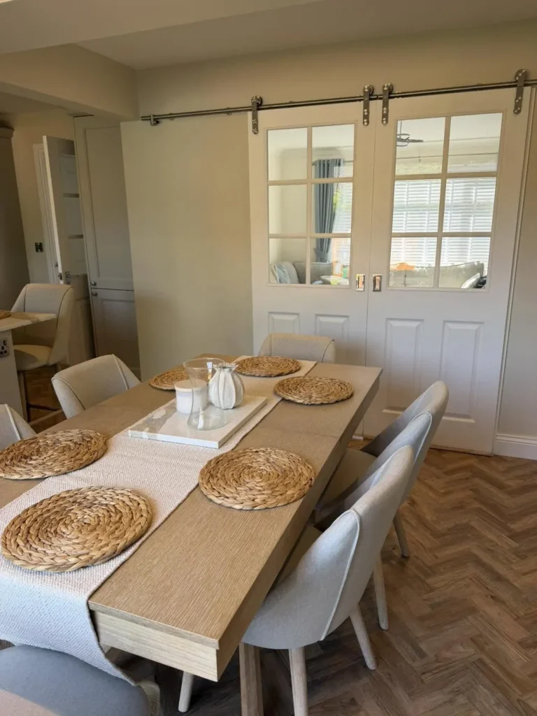 The finished dining area with glazed sliding barn doors